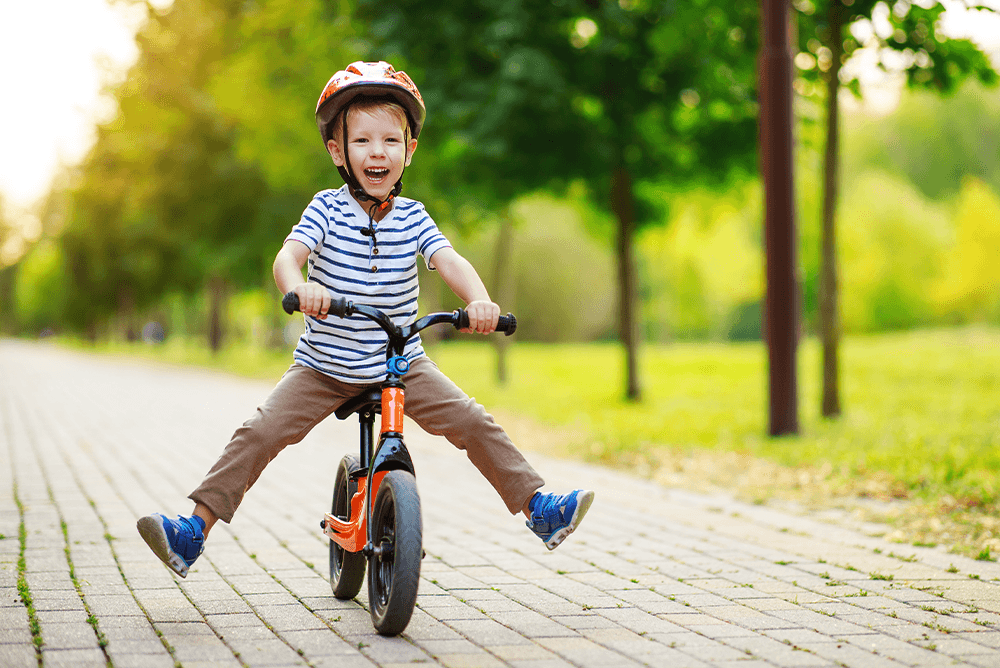 child on a push bike