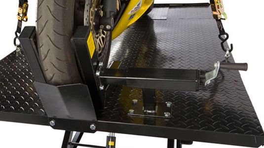 Built-in adjustable wheel clamp vise, wheel stop and tie-down points secure bike to table